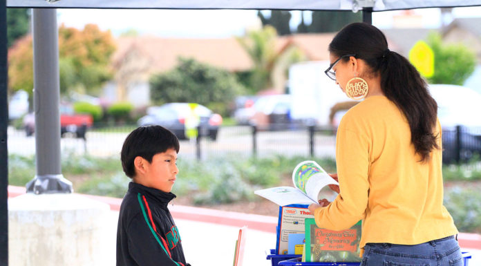 Greenfield teacher hands out books to area youth